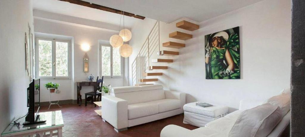 佛羅倫斯的住宿－Santo Spirito Apartment，客厅配有白色沙发和楼梯。