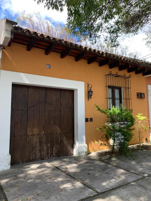 a house with a large wooden garage door at Casa Anabel in Antigua Guatemala