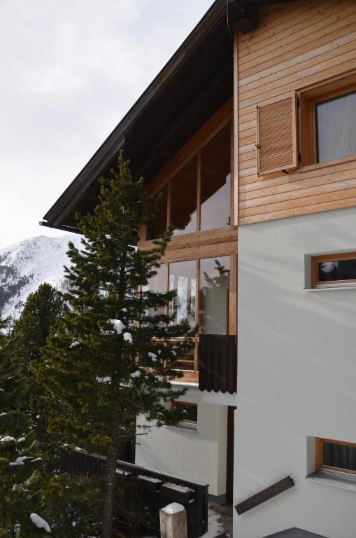 a house with a tree in front of it at Ferienhaus Ferch in Turracher Hohe