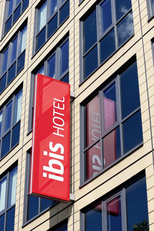 a red sign on the side of a building at ibis München Parkstadt Schwabing in Munich