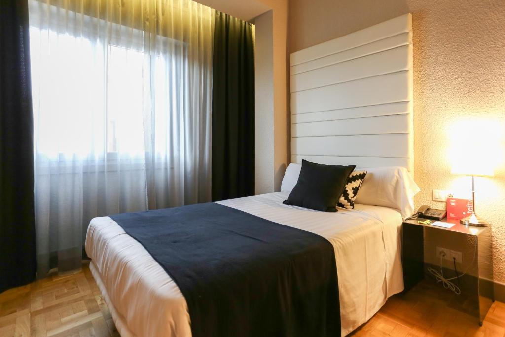 Postel nebo postele na pokoji v ubytování Habitus Hotel Leyre