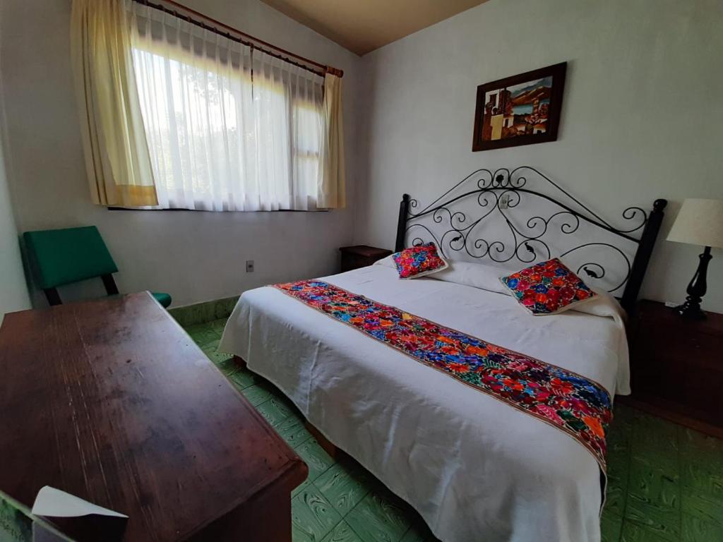 Postel nebo postele na pokoji v ubytování Posada Los Colorines