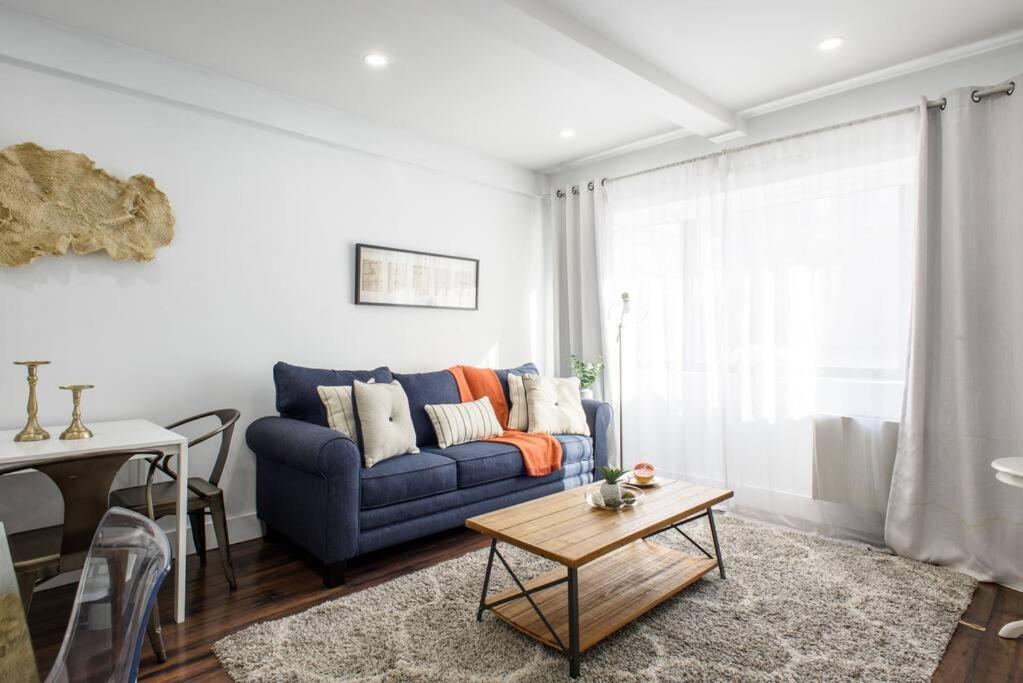 ein Wohnzimmer mit einem blauen Sofa und einem Tisch in der Unterkunft 809-2A Gorgeous 1BR New W D Modern Best Location in New York