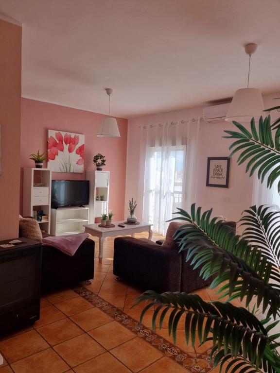 a living room with a couch and a tv at Mar in Isla del Moral