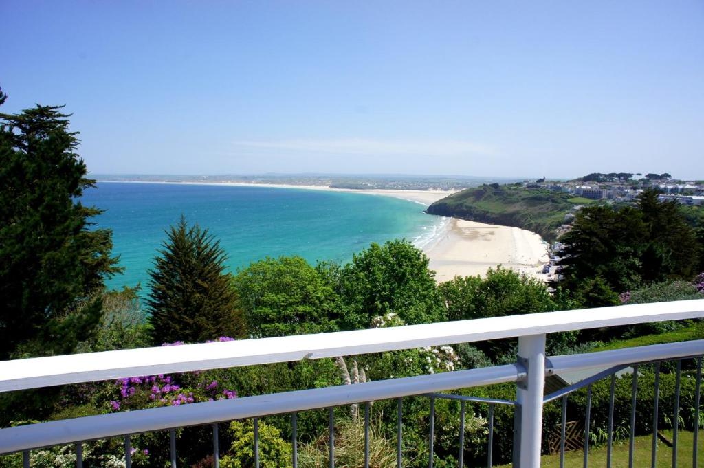 a view of a beach from a balcony at Tremorna Vista in Carbis Bay