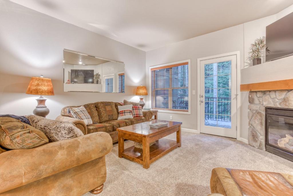 a living room with couches and a fireplace at Creek Ridge Escape in Government Camp
