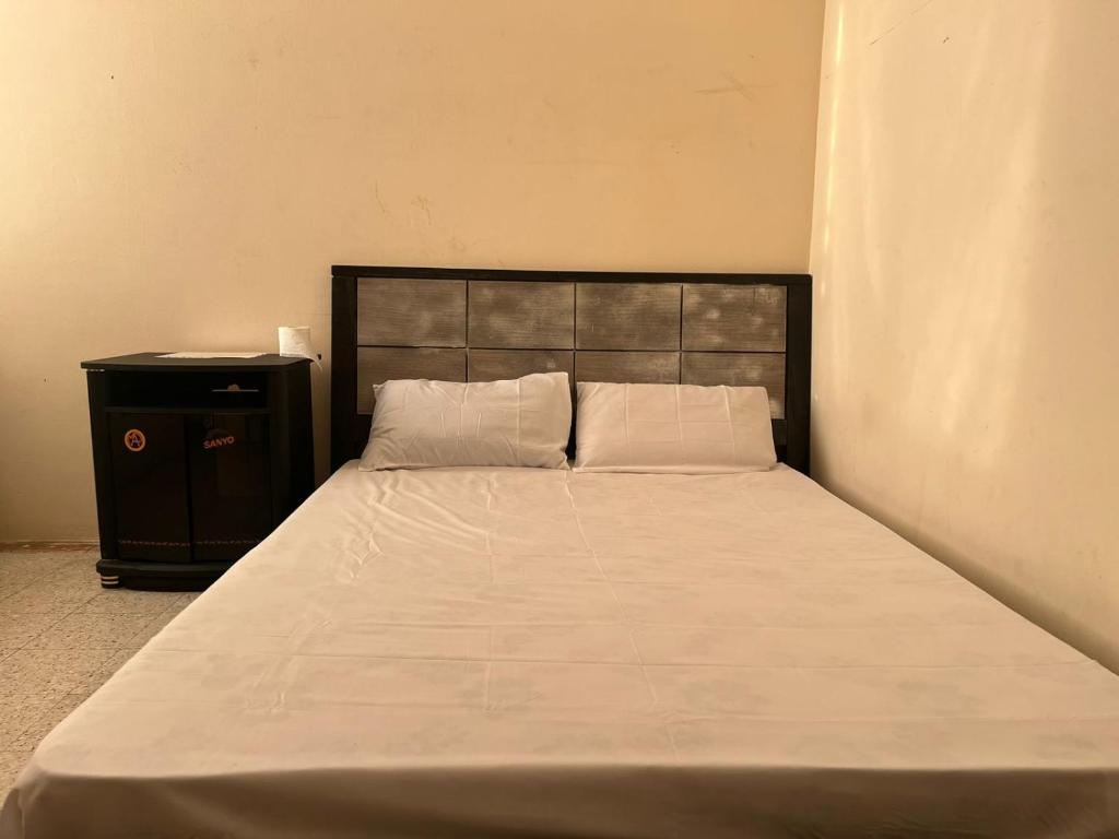 um quarto com uma cama grande e um armário preto em Stay at gomeetingwith em Sharjah