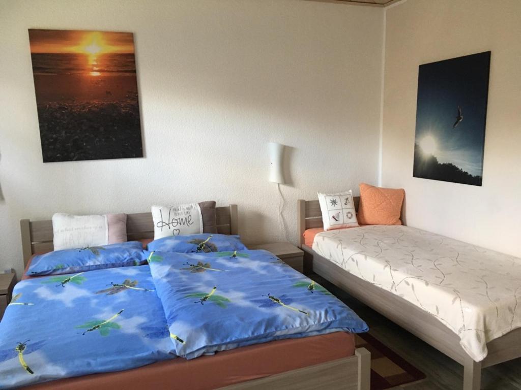 1 Schlafzimmer mit 2 Betten und blauer Bettwäsche in der Unterkunft Ferienwohnung mit Terrasse - Insel Usedom in Trassenheide