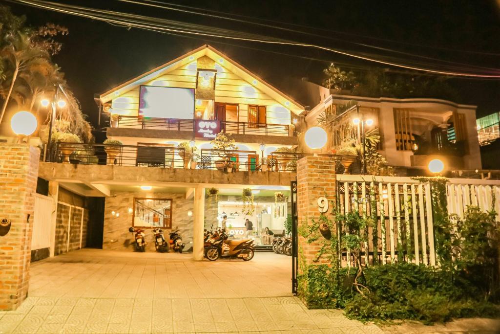 een huis 's nachts met een motor geparkeerd voor bij Lucky Home in Hue