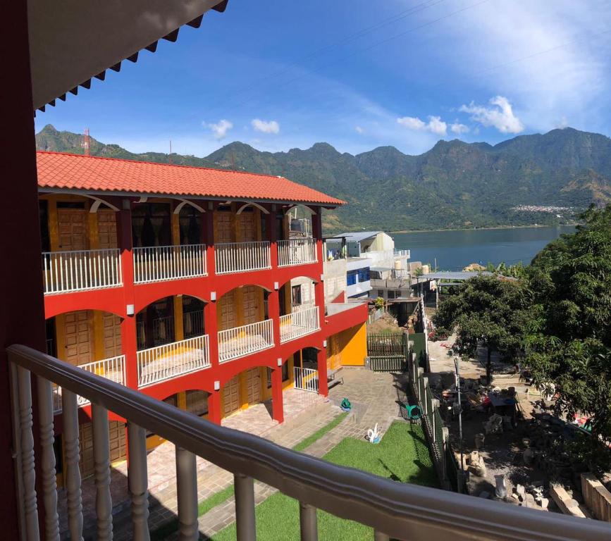 a building with a balcony with a view of the water at Hotel Adulam in San Pedro La Laguna