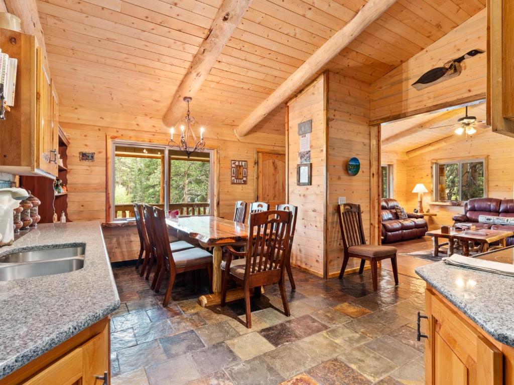 a kitchen and dining room with a table and chairs at Pine Haven Resort in Estes Park