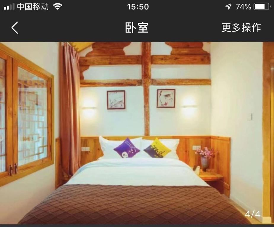 Una cama o camas en una habitación de Honglin Houseg虹林的小院 防疫整栋 古城里温馨私家小院 享受大理慢时光 树下喝茶聊天 烧烤娱乐自助厨房 休闲好去处