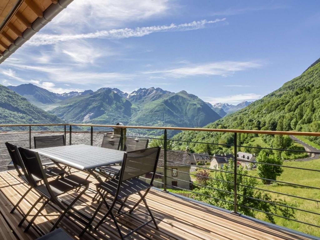 a table and chairs on a balcony with a view of mountains at Maison neuve à Grust pour 12 personnes, 4 chambres, WIFI, parking, linge et ménage inclus - FR-1-402-110 in Grust