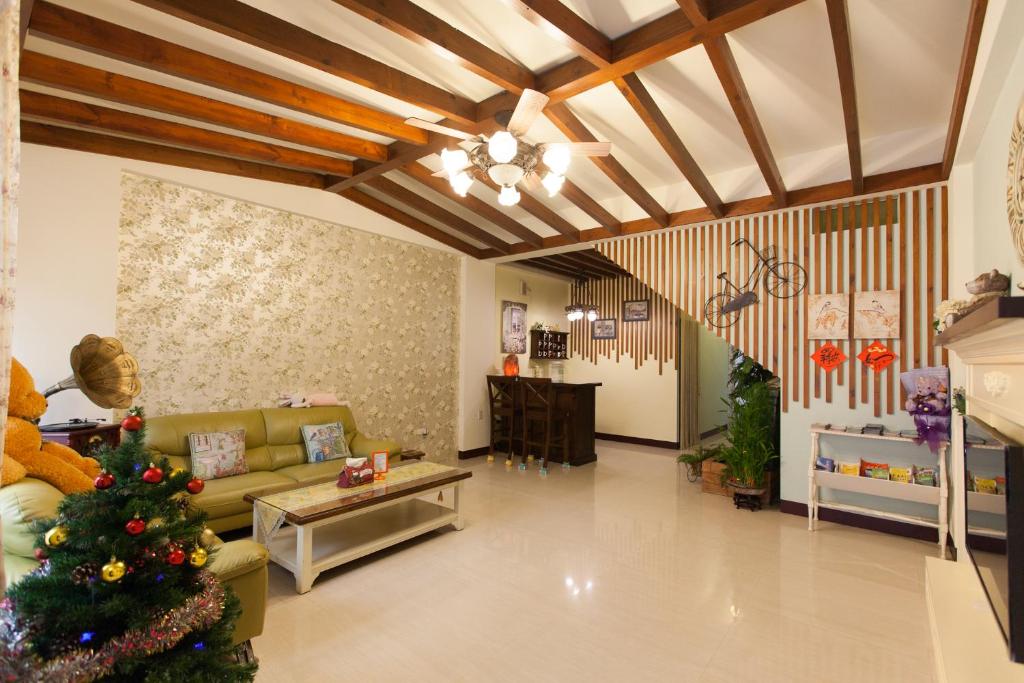 a living room with a christmas tree in it at Happiness Homestay in Hualien City
