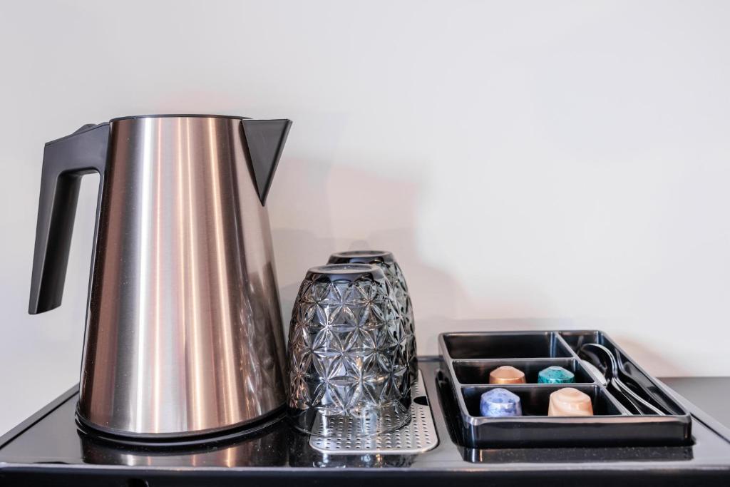a tea kettle and a tray of chocolates on a stove at No 8 Bed & Bar in Verbier