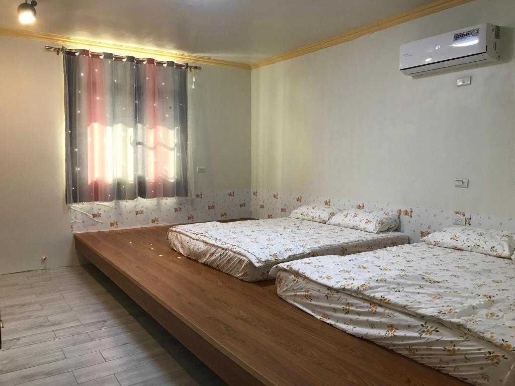 Postel nebo postele na pokoji v ubytování 嘉義行滿旅宿&包棟親子寵物烤肉平價好趣宿