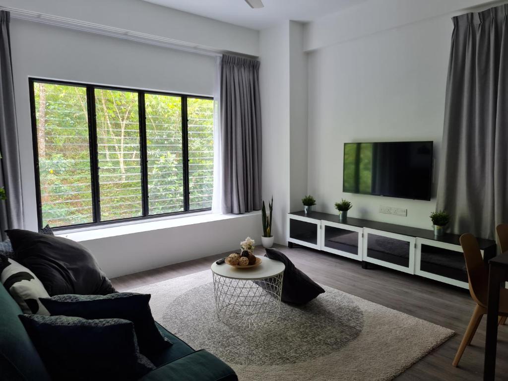 sala de estar con sofá y TV en 4-7 Pax Genting View Resort Kempas Residence -Free Wifi, Netflix And Free Parking, en Genting Highlands