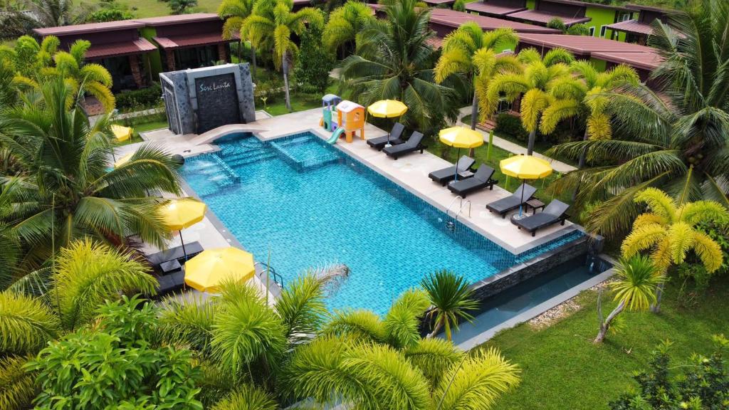 an overhead view of a swimming pool with palm trees at Siri Lanta Resort in Ko Lanta