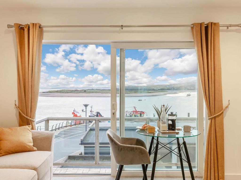 a living room with a view of the water at Estuary View in Exmouth
