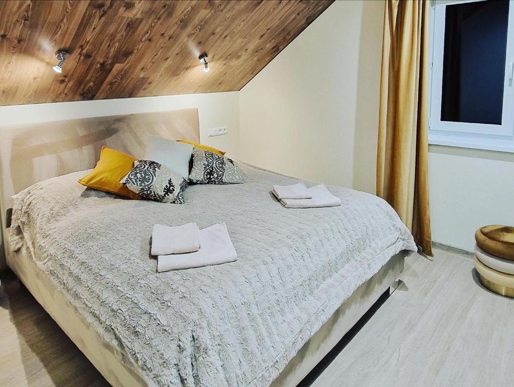 a bedroom with a bed with two towels on it at Apartmány “Chaty Krušetnica “ in Krušetnica
