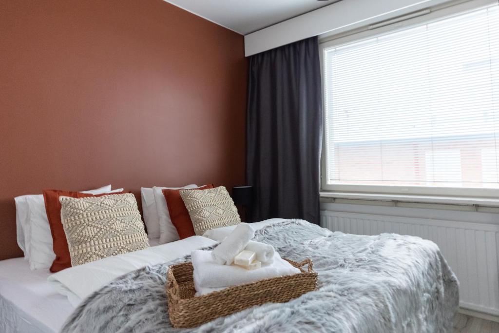 a bedroom with a bed with towels on it at Arctic Night City Suite in Rovaniemi