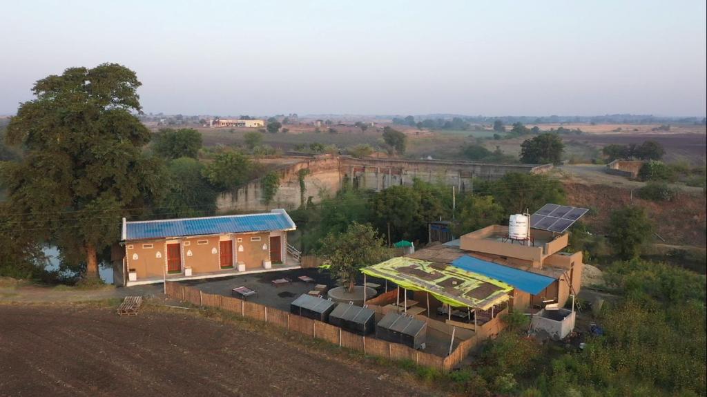 an aerial view of a house with a solarium at Tarangini Farmstay in Maheshwar