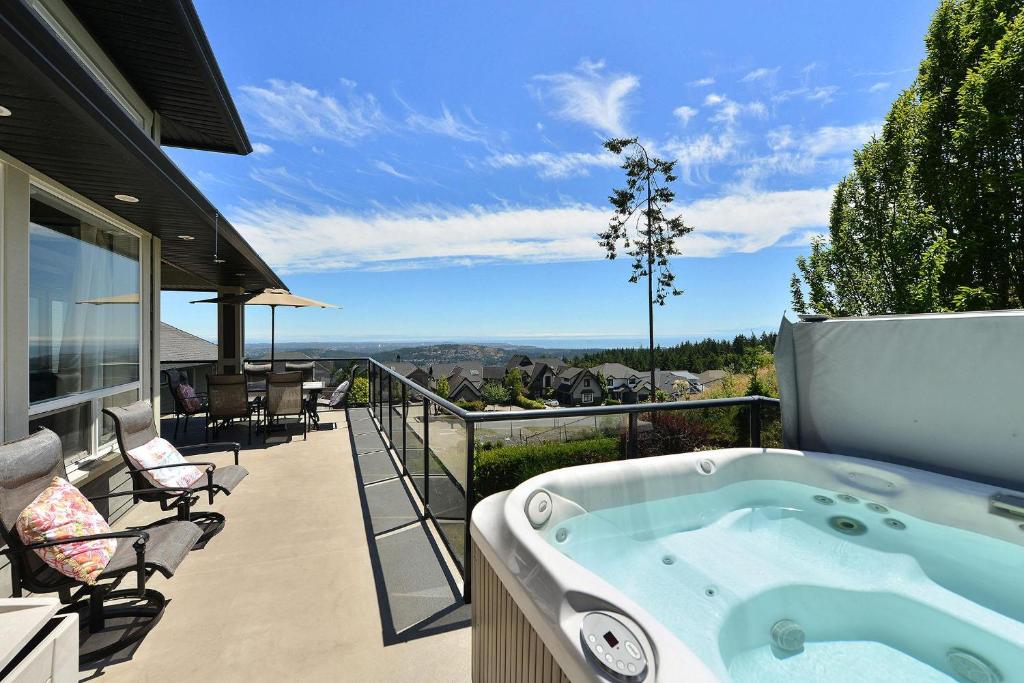a hot tub on the balcony of a house at Nature's Gate Executive Estate in Victoria