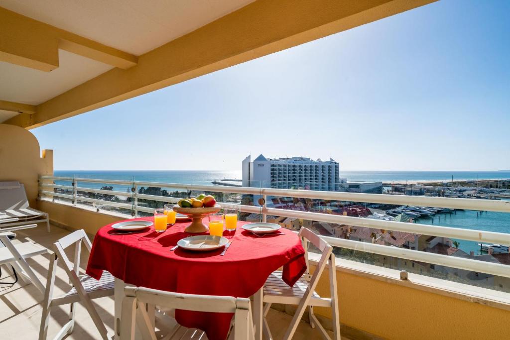 a table on a balcony with a view of the ocean at Marina Mar 'Penthouse' by SAPvillas in Vilamoura