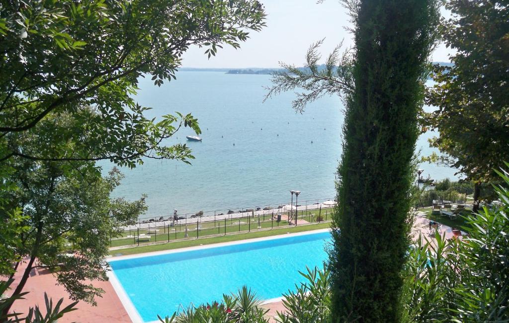 a swimming pool with a view of the water at Gardazzurro in Padenghe sul Garda