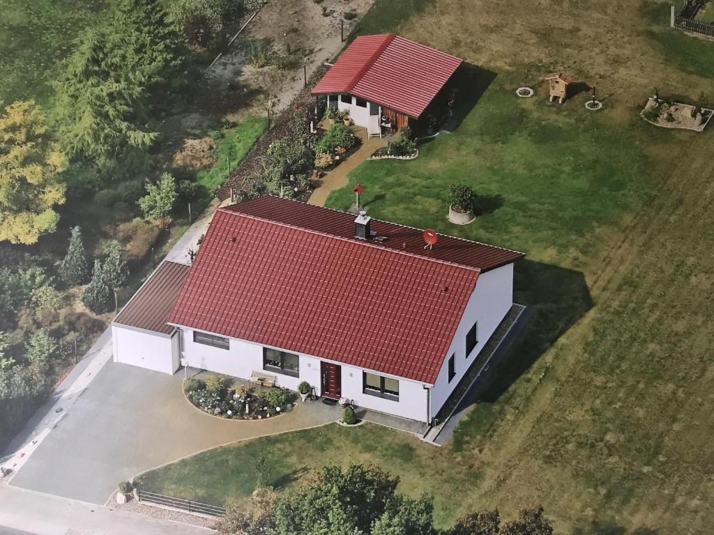 an overhead view of a white house with a red roof at Ferienhaus Willmann in Böhme