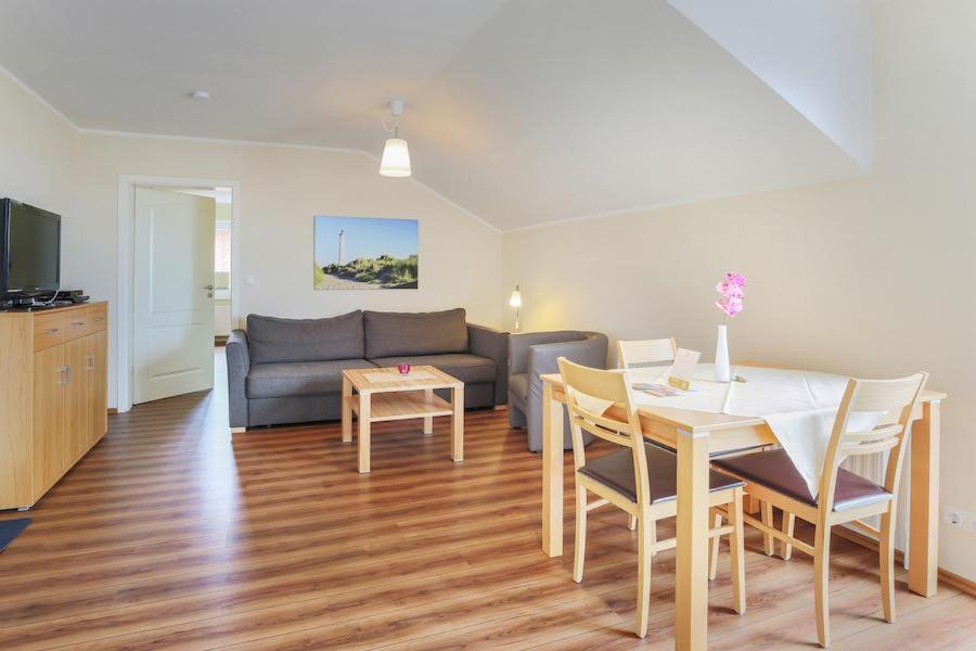 a living room with a table and a couch at Buedlfarm-NordOst in Sahrensdorf