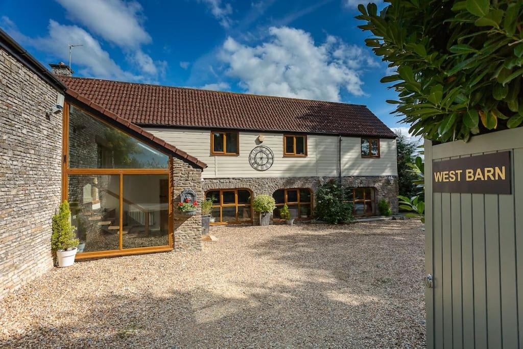 a barn conversion with a guest barn and a building at The West Barn near Bath, sleeps 24 and 2 hot tubs in Bristol