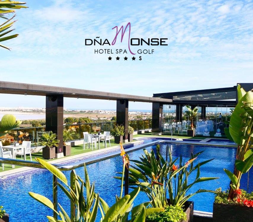 a view of the pool at the dkm universe hotel spaurt at Dña Monse Hotel Spa & Golf in Torrevieja