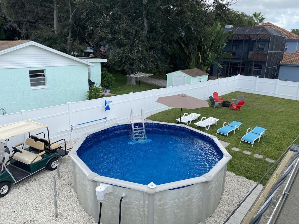 an overhead view of a swimming pool with a golf cart next to it at Cozy Home in a Golf kart neighborhood and private pool in Palm Harbor