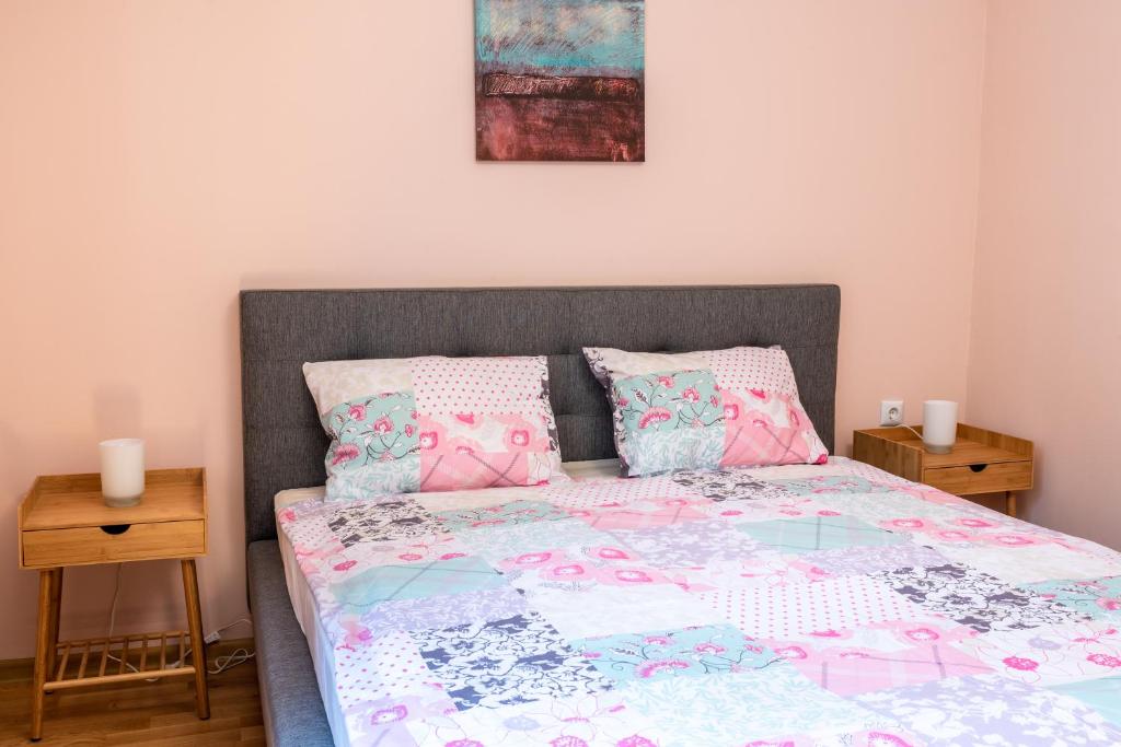 a bedroom with a bed with pink and blue sheets and pillows at Bendida Park in Velingrad