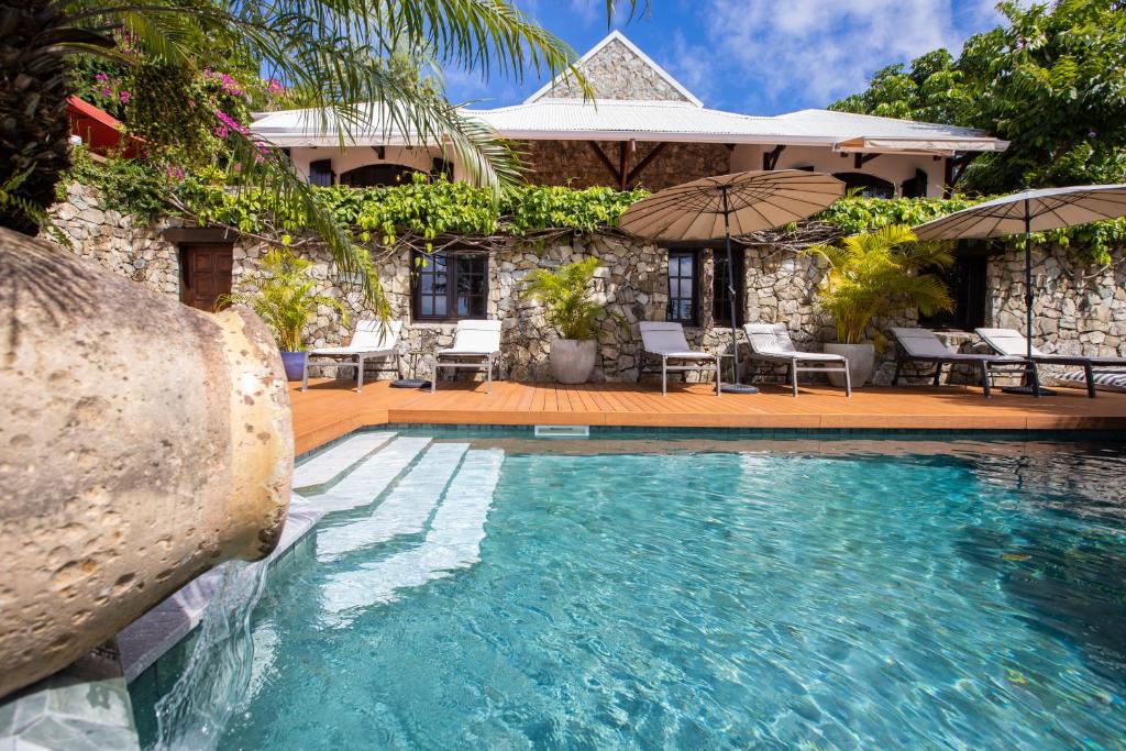 a swimming pool in front of a house at The Paradise Peak in Saint Martin