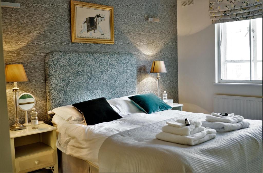 a bedroom with a bed with towels on it at Double room in Marylebone in London
