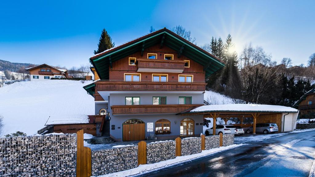 a large house in the snow with a fence at Haus Michael Tritscher in Schladming