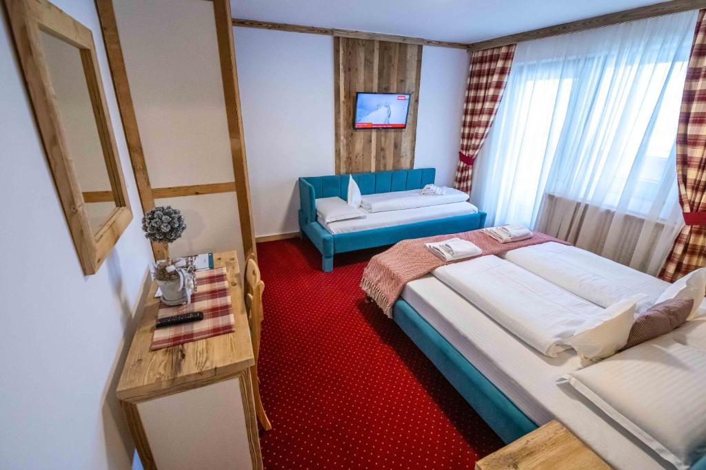 Postel nebo postele na pokoji v ubytování KITZALPEN Pension
