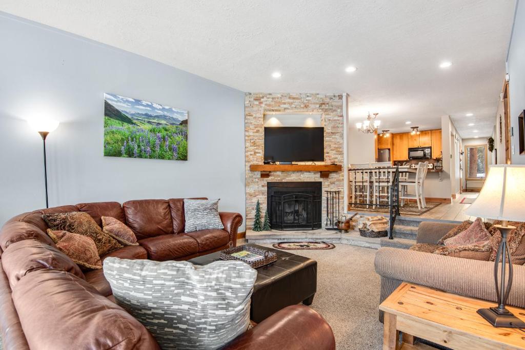 a living room with a couch and a fireplace at Pines Foxtail 2046 in Keystone