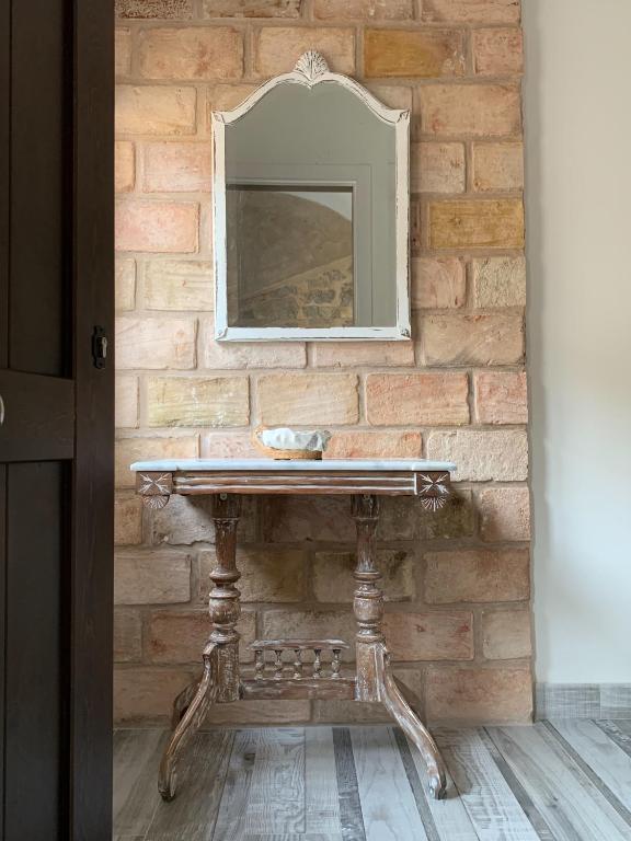 a stone wall with a sink and a mirror at Casa Chus in Albarracín
