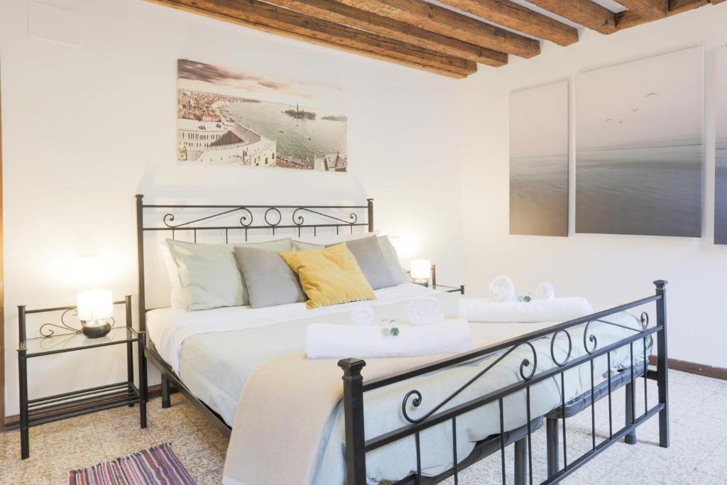 a bedroom with a black and white bed and two tables at SANTA CROCE GUEST HOUSE in Venice