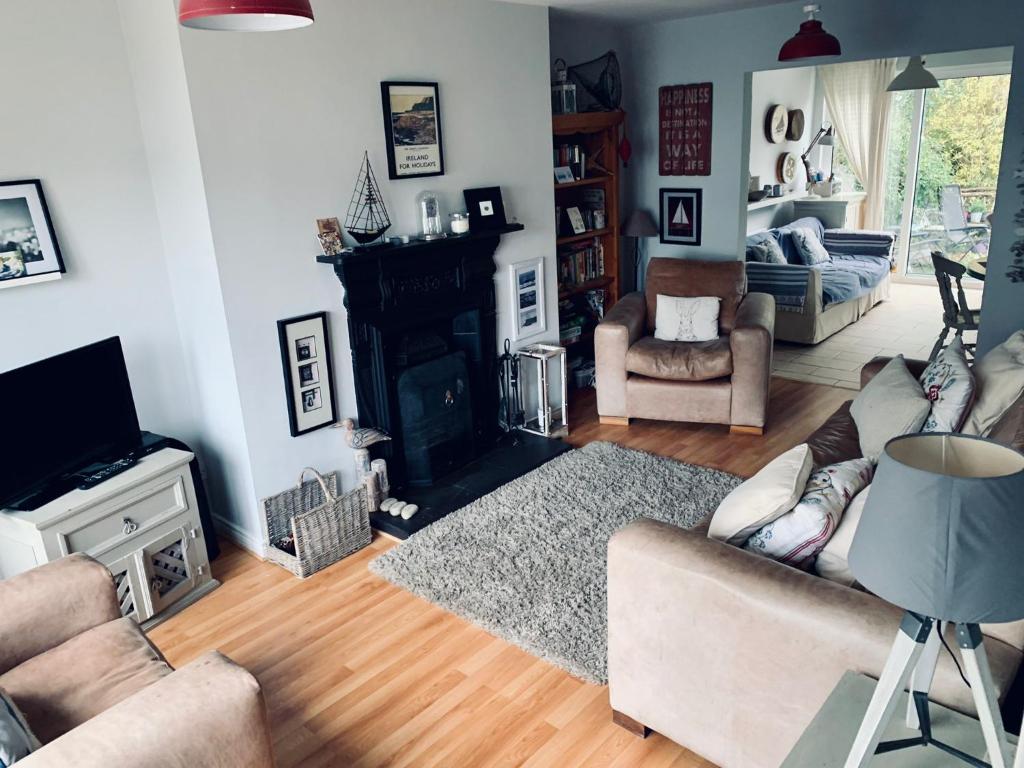 a living room with a couch and a fireplace at Ballycastle Holiday Home in Ballycastle
