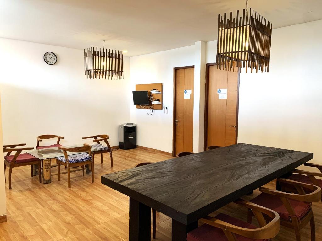 a dining room with a table and chairs at Ozora Tiying Tutul Hostel Canggu in Canggu