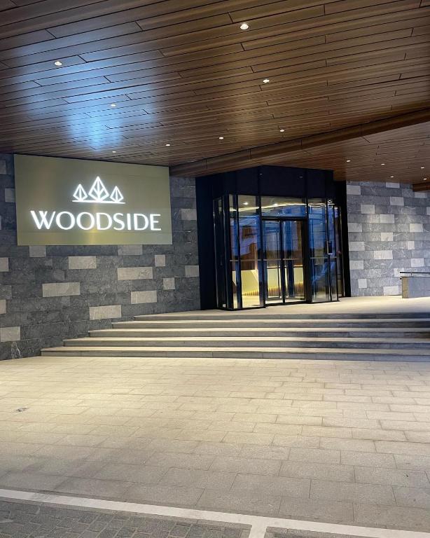 a woodside sign on the side of a building at Woodside Apartment 431, Kopaonik - One separate bedroom 35m2- FREE Parking & SPA in Kopaonik