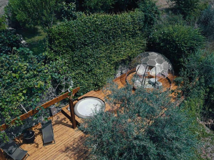 an overhead view of a wooden deck in a garden at @LaCasettasulFiume in Sarnico