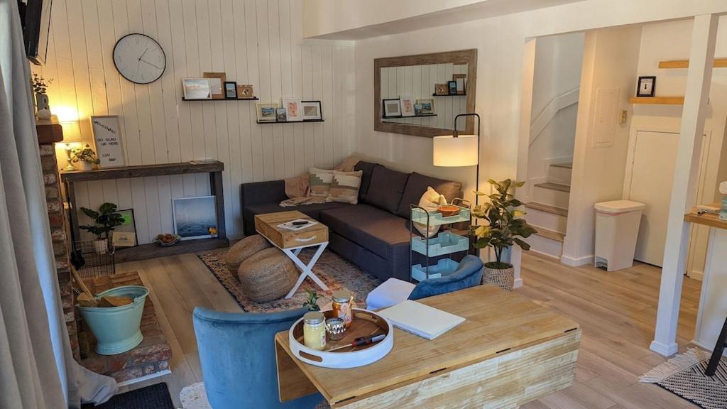 a living room with a couch and a table at Cozy condo walking distance to village and gondola w/ pool/ jacuzzi sleeps 4. in Mammoth Lakes