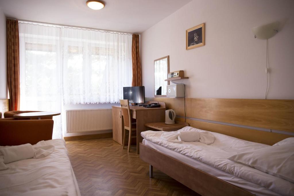 Postel nebo postele na pokoji v ubytování Ośrodek Wypoczynku i Rekreacji Venus