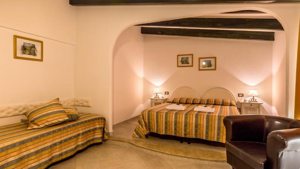 Postel nebo postele na pokoji v ubytování Hotel Cala Di Seta