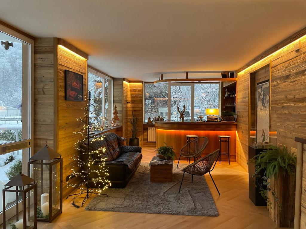 a living room with a couch and a christmas tree at HOTEL LE FONTI in Lurisia